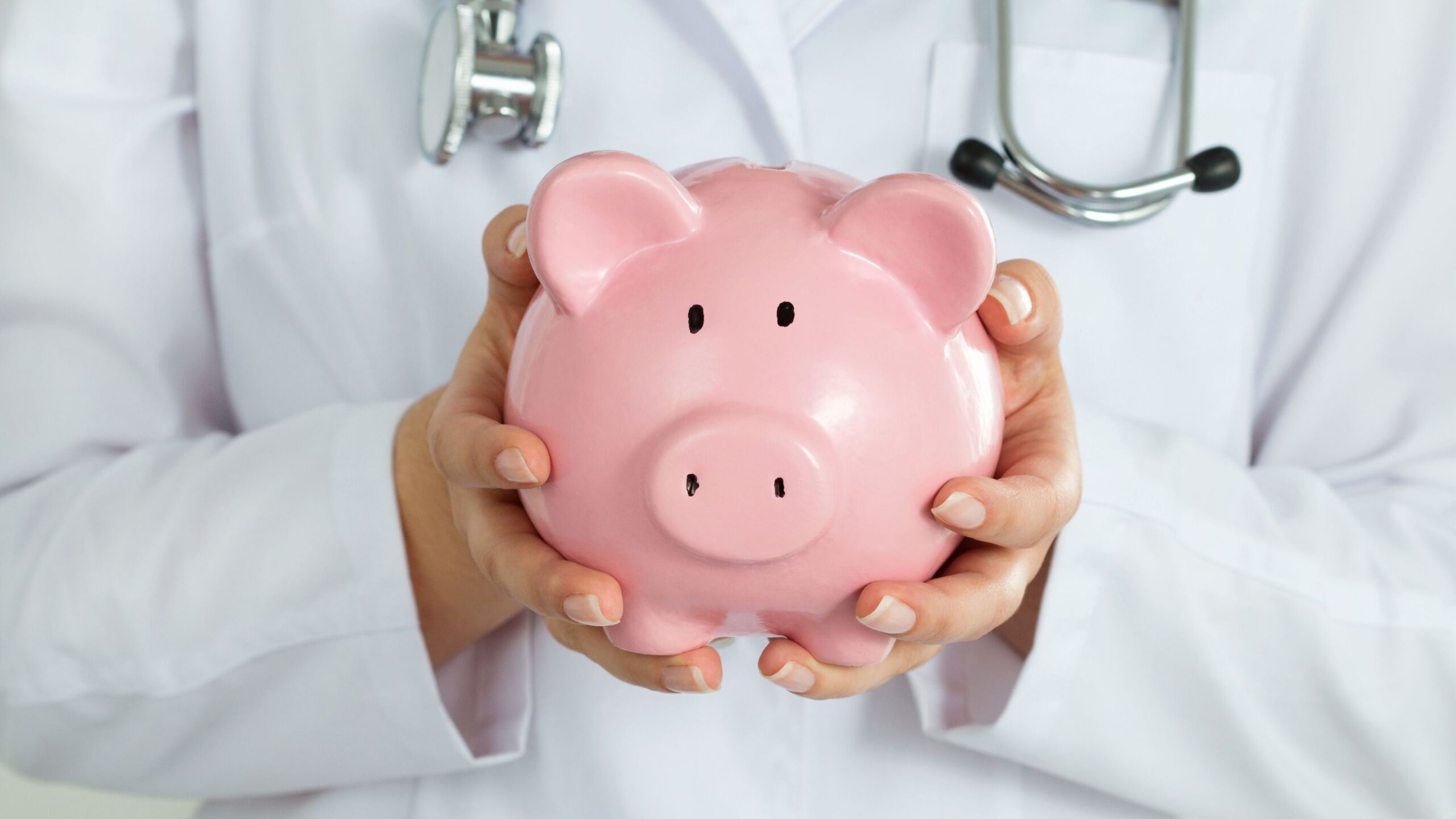 A doctor in a lab coat holding a pink piggy bank representing how much do sperm donors make