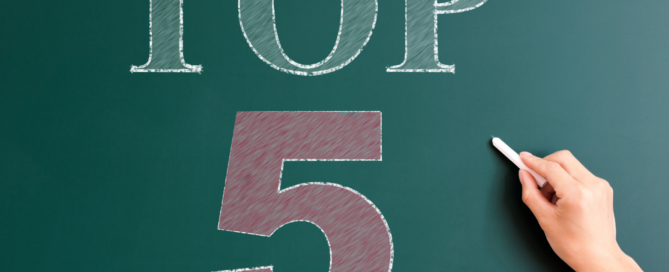 A dark green chalk board that reads, top 5.