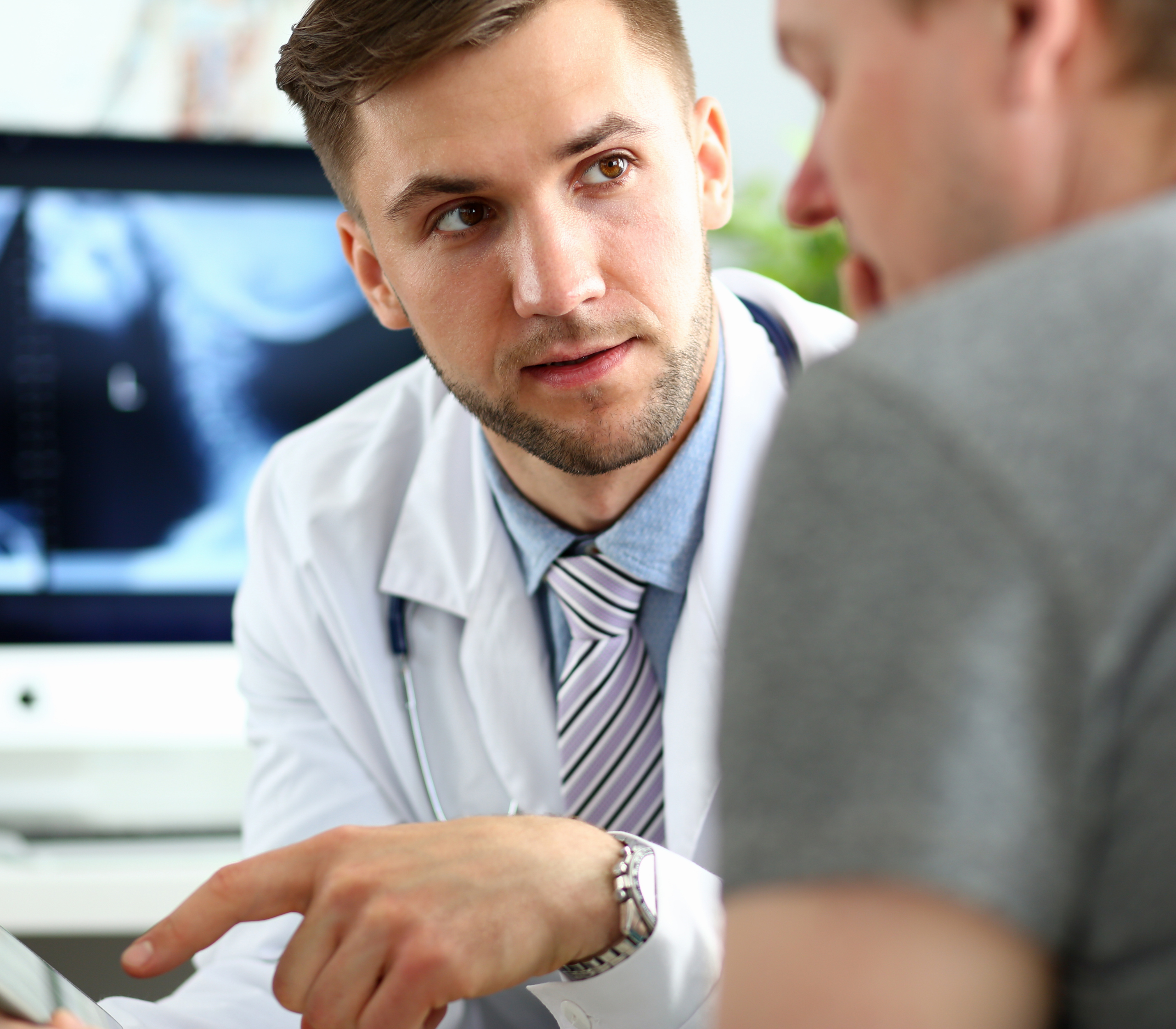 A Doctor talking with a male patient about what disqualifies you from being a sperm donor